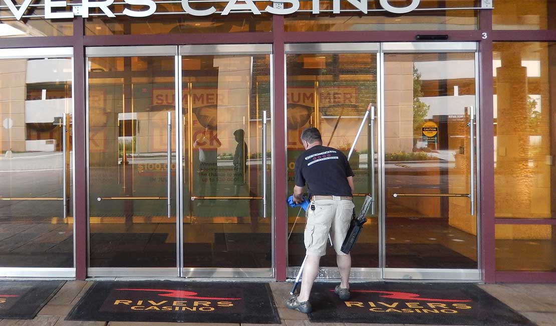 man cleaning door at casino